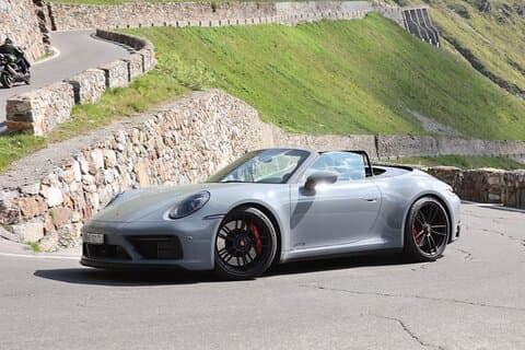 Porsche 911 driving on Stelvio Pass in Italy