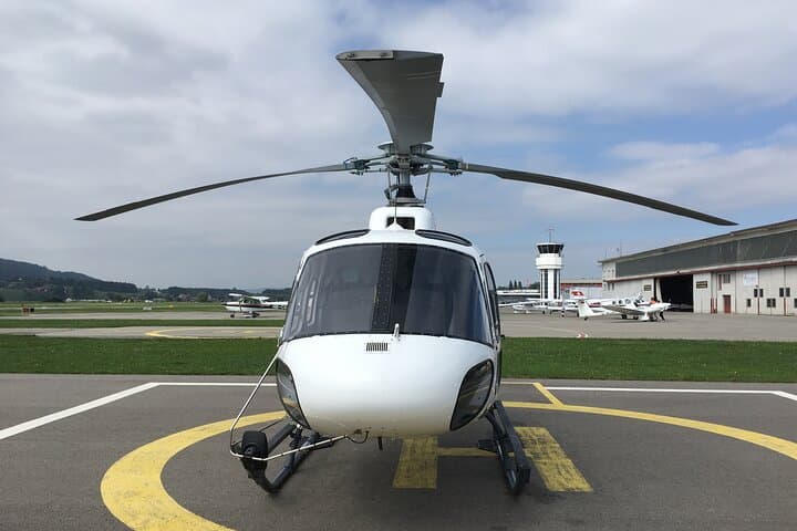 The helicopter flight starts from the Swiss capital airport and takes you over the turquoise blue Lake Thun.