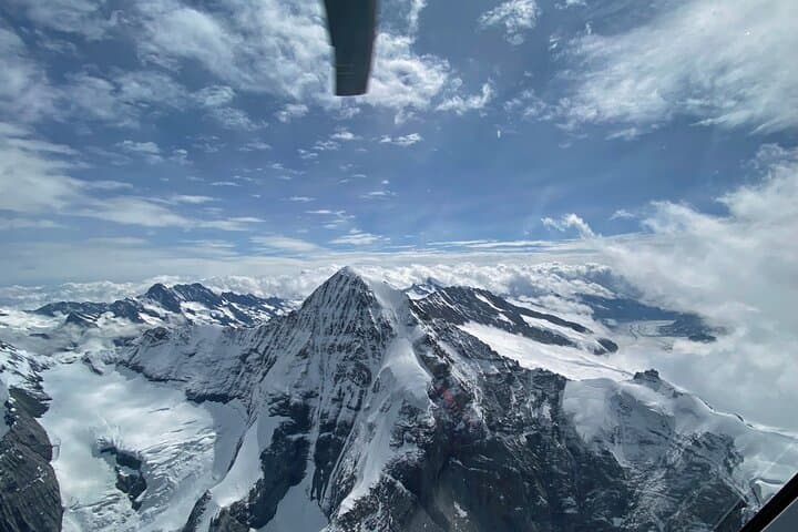 The view out of the helicopter cockpit over the Eiger north face.