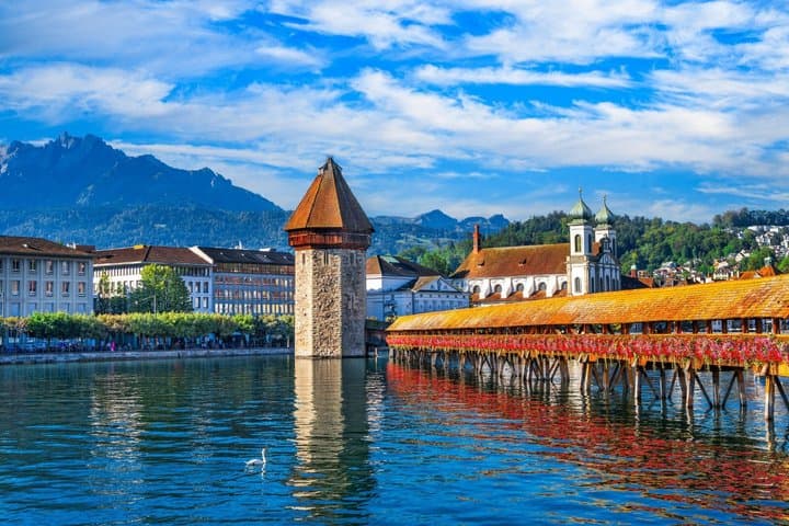 Chapel Bridge (Kapellbrücke): The absolute emblem of the city, the oldest covered wooden bridge in Europe, recognizable by its octagonal Water Tower.